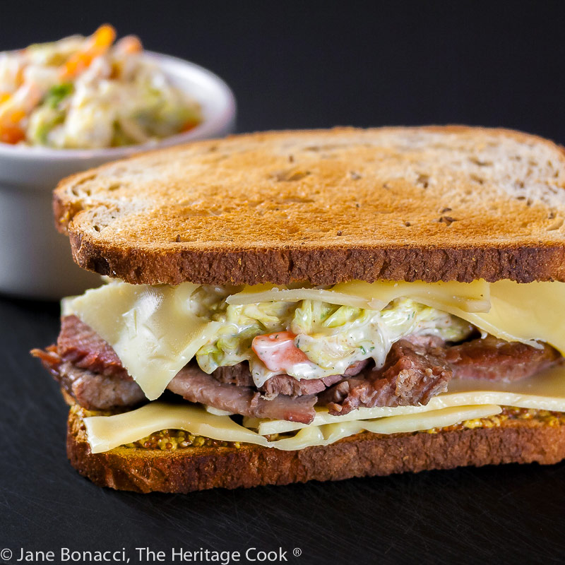 sandwich in front of cup of slaw; Corned Beef Sandwiches with Dill-Ranch Coleslaw © 2022 Jane Bonacci, The Heritage Cook