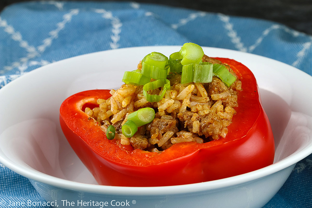 stuffed pepper in white bowl; Mexican Beef and Rice Stuffed Peppers © 2022 Jane Bonacci, The Heritage Cook 