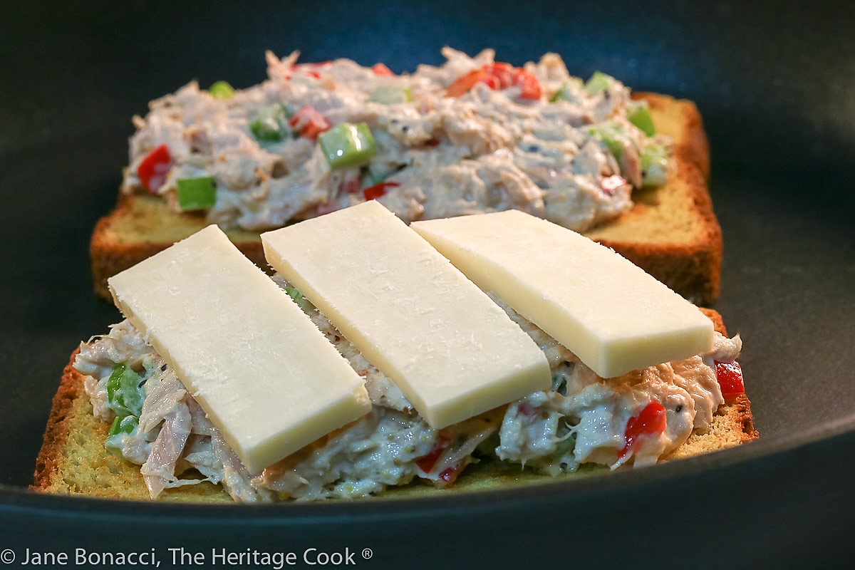 Frying the sandwiches before sliding under the broiler and melting the cheese; California Tuna Melts (Gluten Free); grilled tuna salad sandwiches with cheese and avocado © 2022 Jane Bonacci, The Heritage Cook