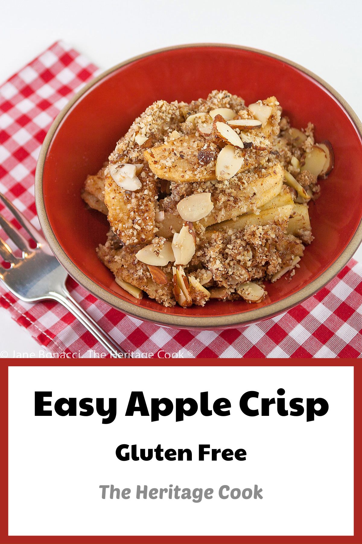 Sweetened apple filling and crispy topping with almonds served in a red bowl; Gluten-Free Apple Crisp © 2022 Jane Bonacci, The Heritage Cook.
