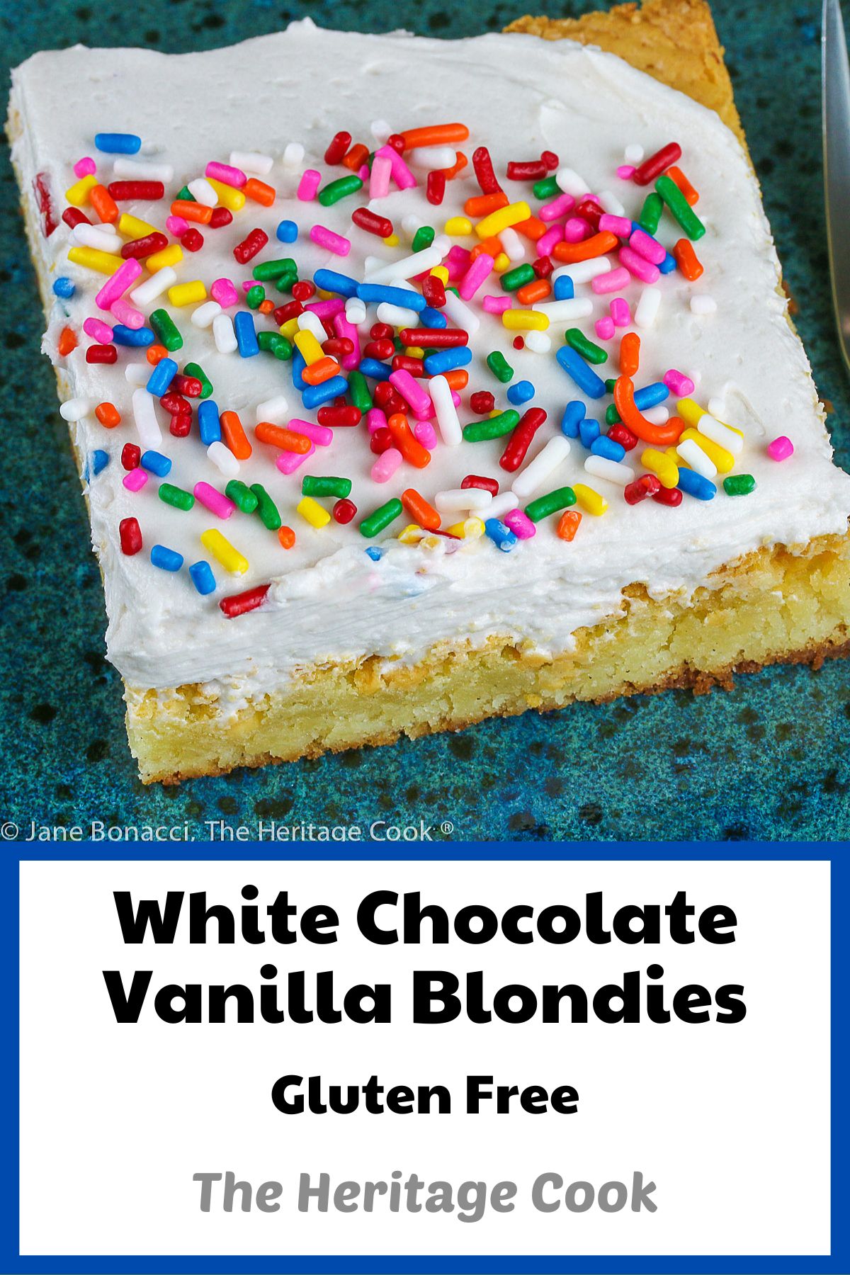 Square blondie with rainbow sprinkles on top on blue plate; White Chocolate Vanilla Blondies © 2022 Jane Bonacci, The Heritage Cook.