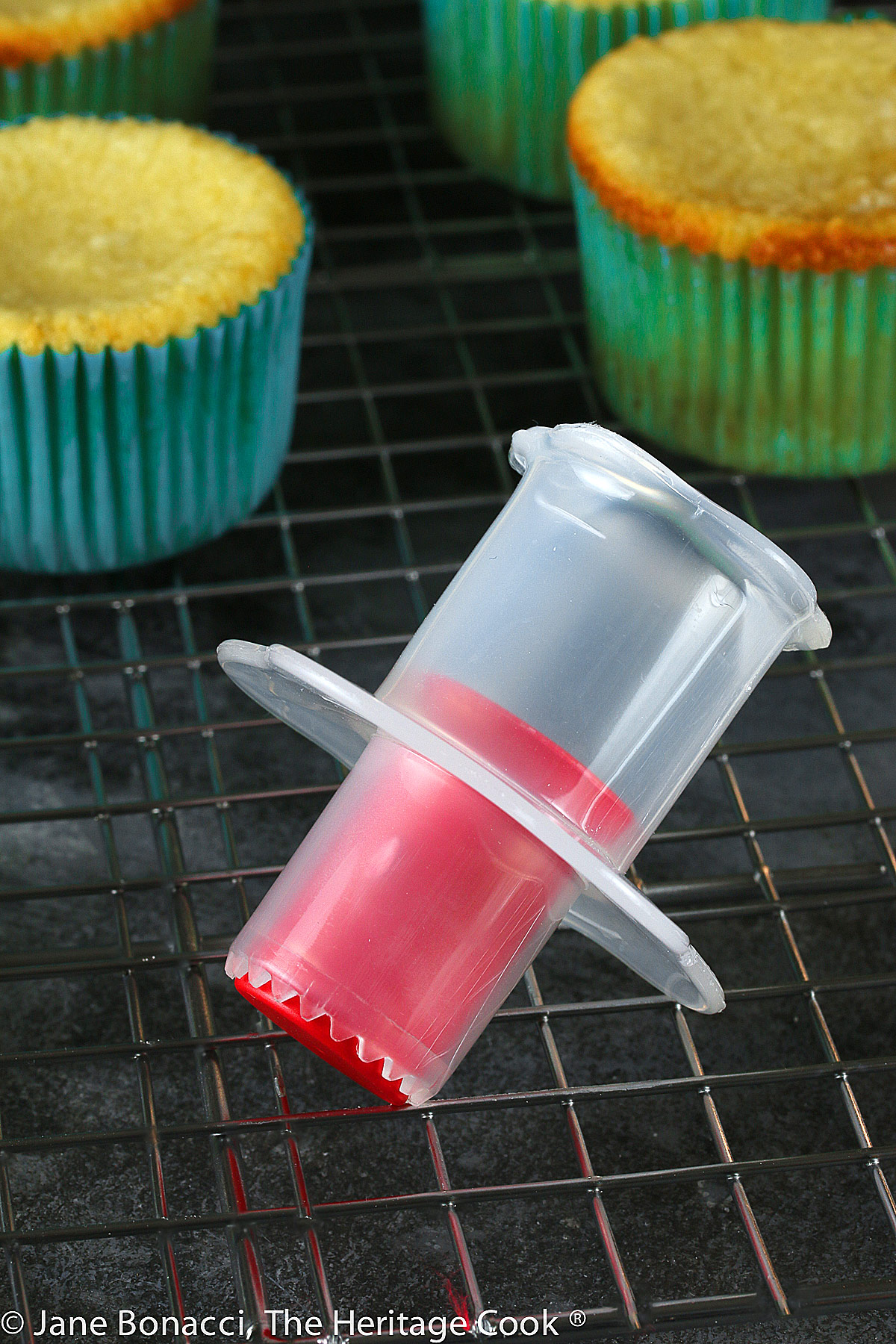 picture of a cupcake corer in front of baked cupcakes. 
