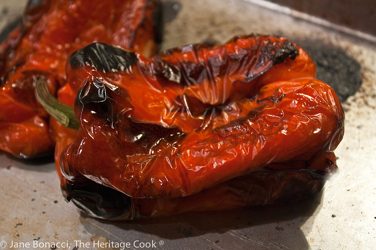 Roasted red peppers ready for steaming and peeling