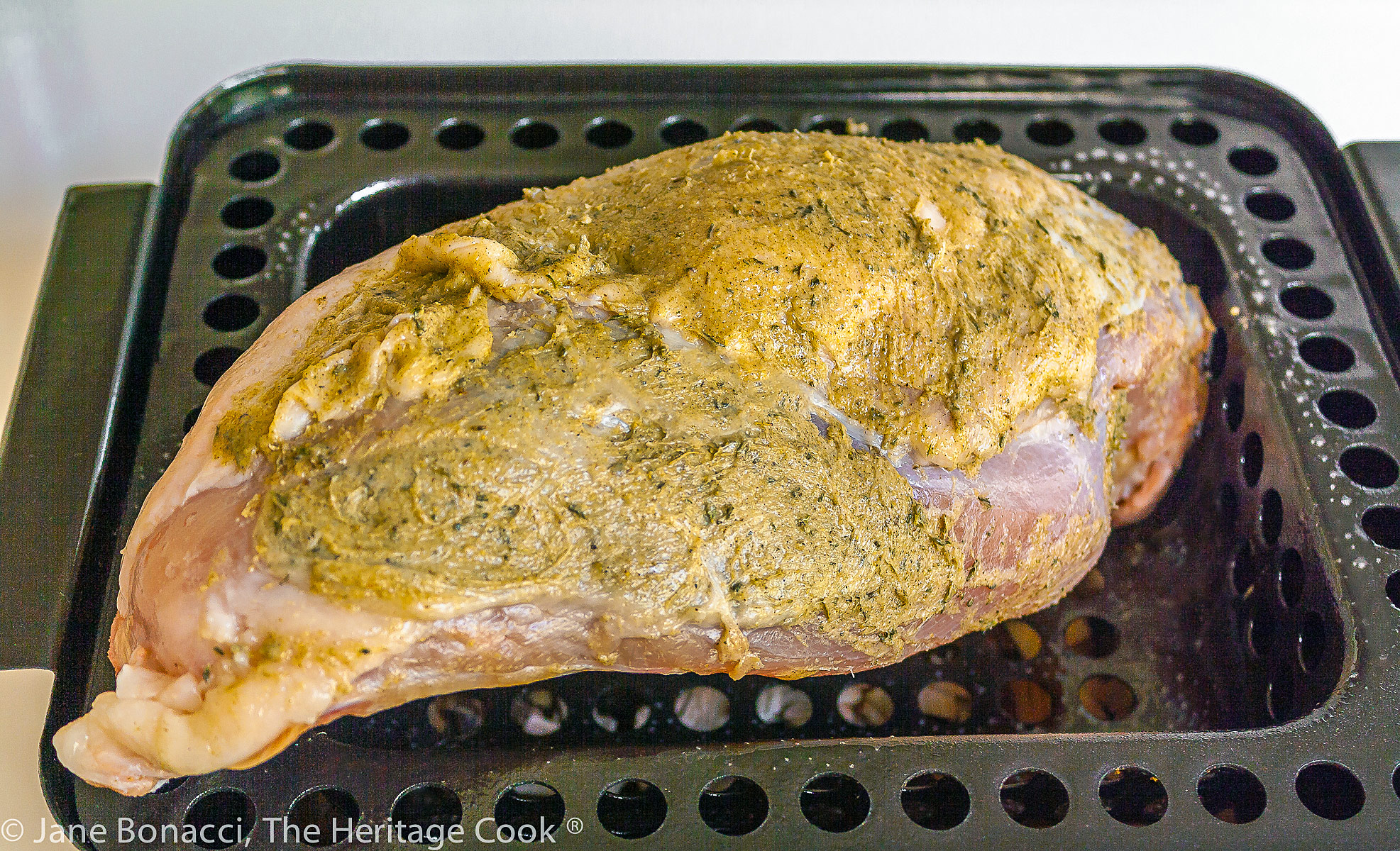 raw turkey breast with compound butter smeared all over it. 