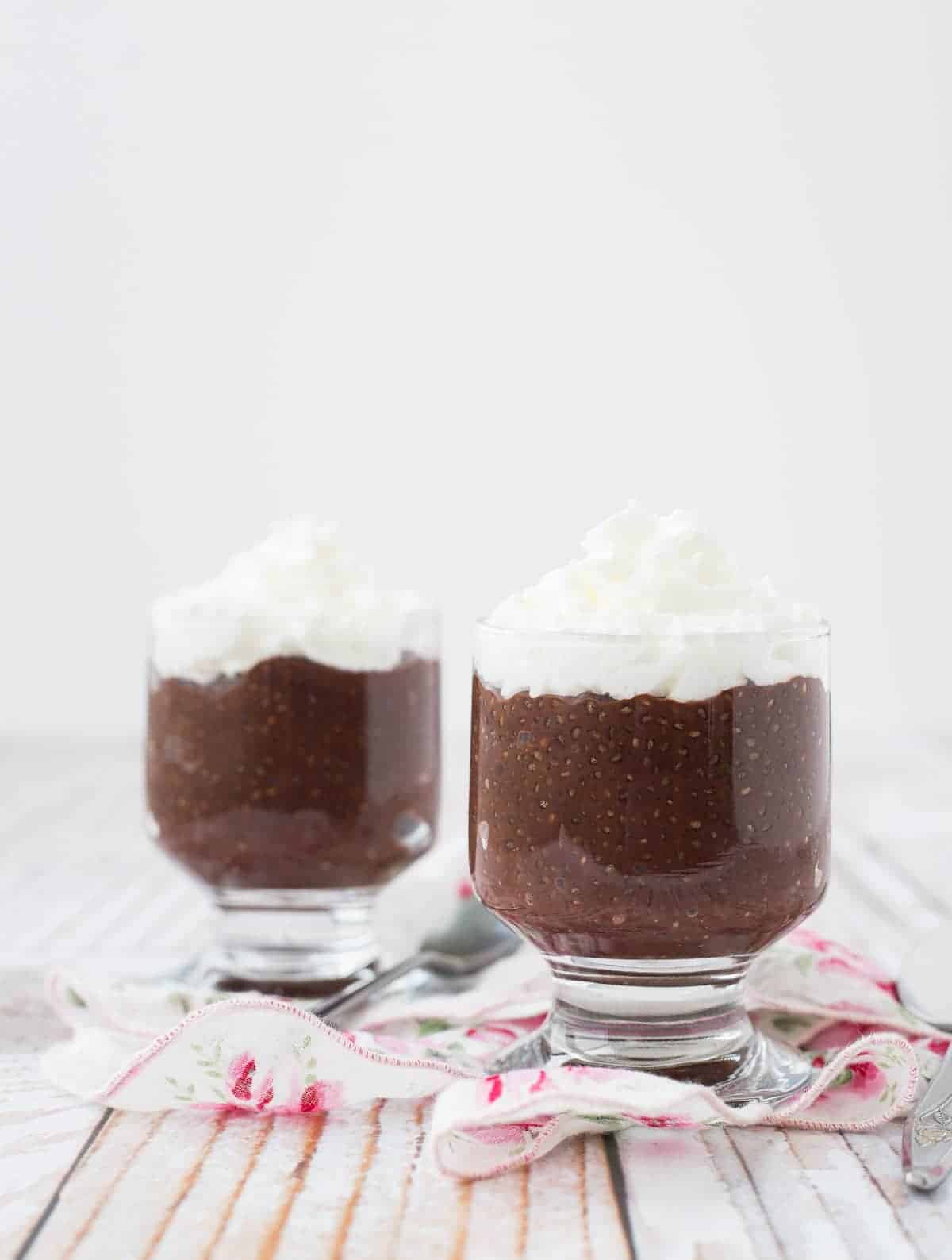 cups of Chocolate Chia Pudding with whipped cream on top; Part of a round-up collection of recipes compiled by Jane Bonacci, The Heritage Cook, 15 Chocolate Desserts for your Holiday Table. 