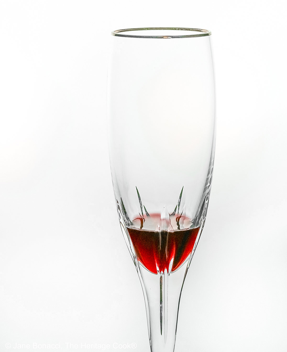 Crystal flute with a little deep red creme de cassis in the bottom, waiting for the champagne.