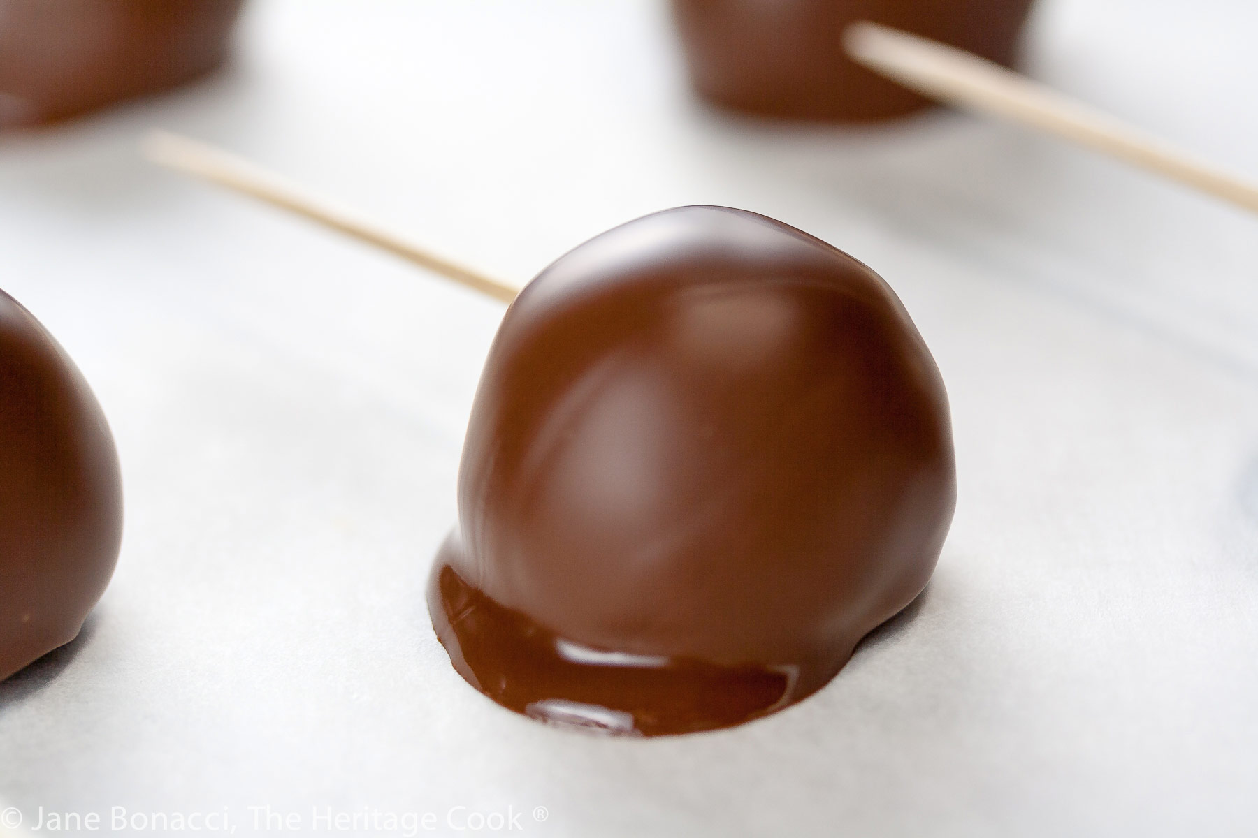 Dipped truffles with toothpicks in each one. 