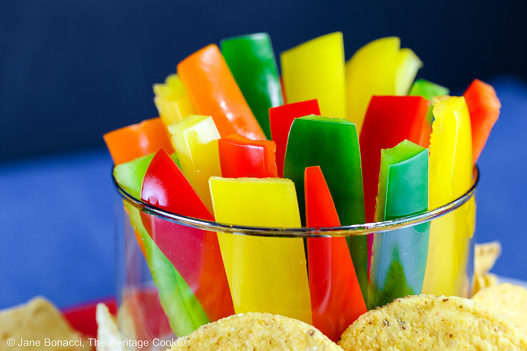 Multi-colored bell pepper strips and tortilla chips for dipping.