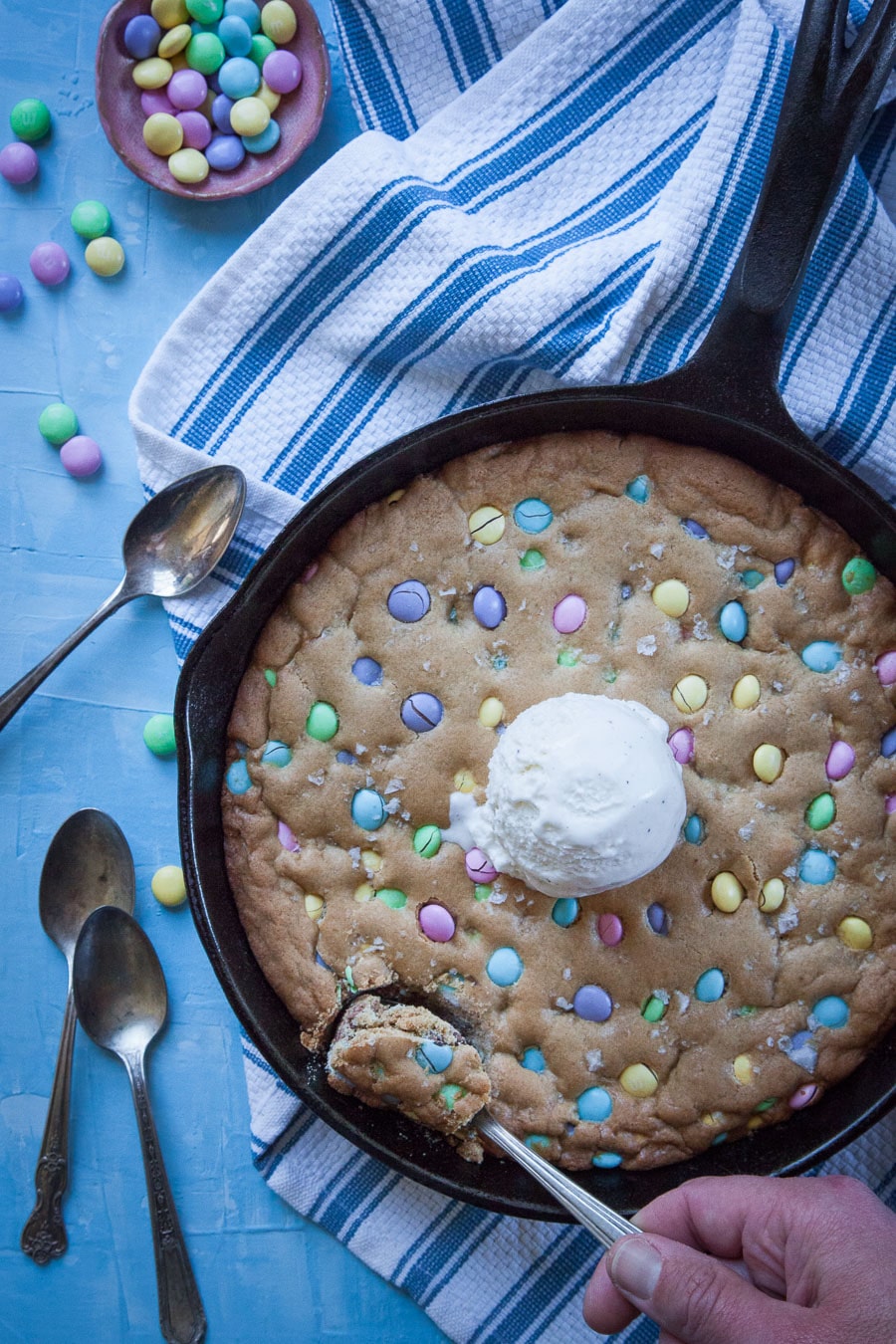 Skillet cookie studded with pastel M&Ms; 21 different chocolate treats in this blog post round-up are swoon-worthy; 21 Chocolate Easter Treats round-up 2023; assembled by Jane Bonacci, The Heritage Cook. 