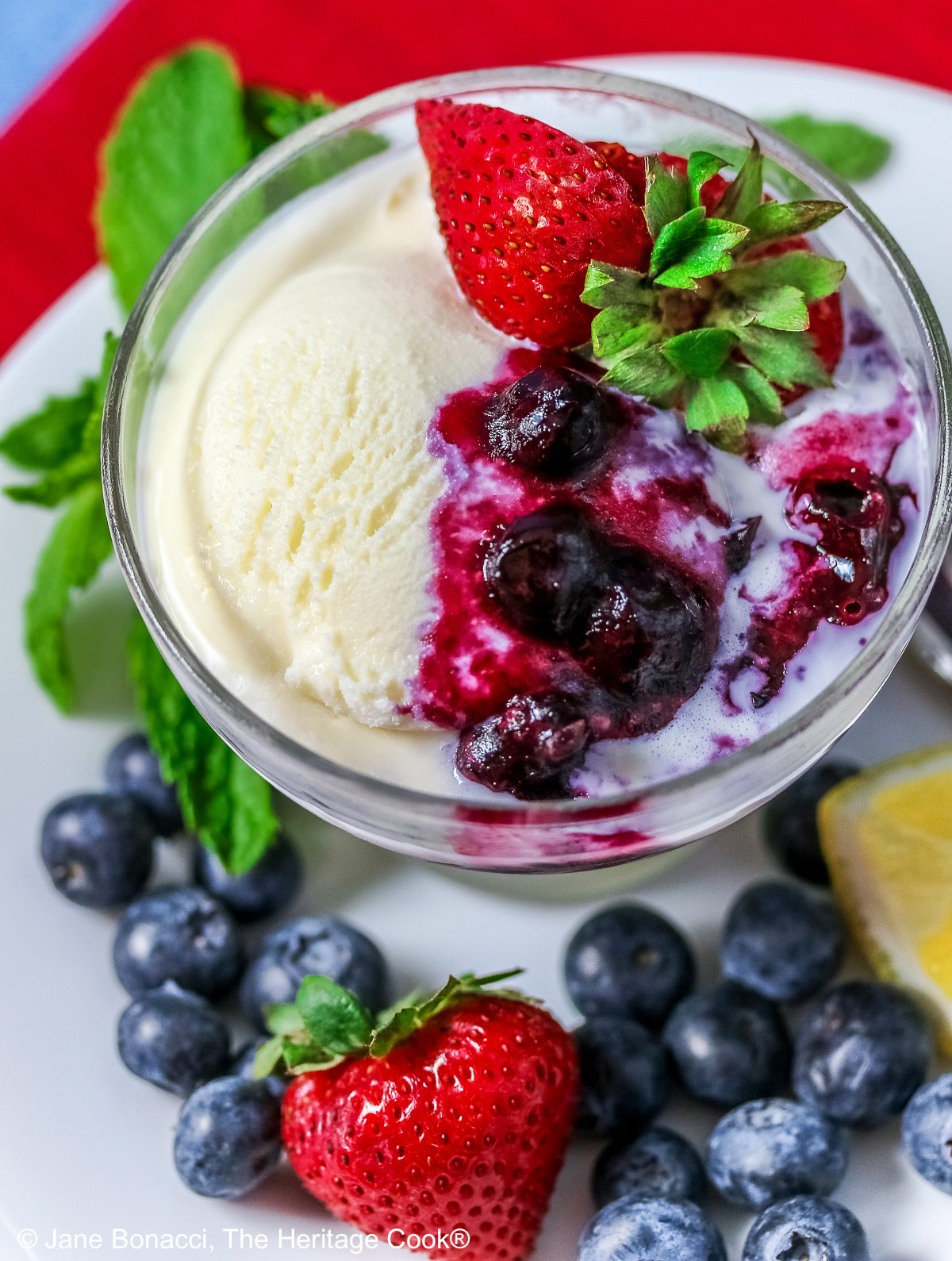 Vanilla ice cream topped with fresh blueberry sauce, berries, red strawberries, and mint; Collection of 10 of the Best 4th of July Chocolate Treats compiled by Jane Bonacci, The Heritage Cook.