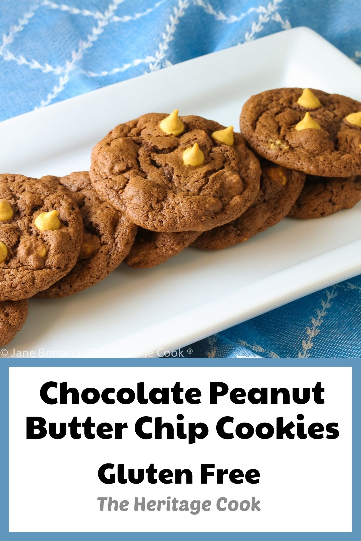 Chocolate cookies with lighter peanut butter chips on top on a white rectangular platter © 2023 Jane Bonacci, The Heritage Cook. 