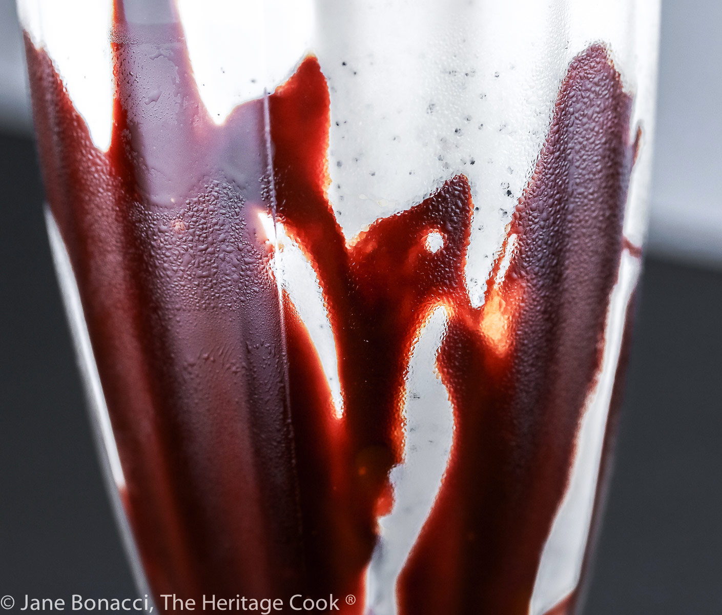 A hummingbird eating at a feeder appeared in the abstract chocolate swirl in the glass! 