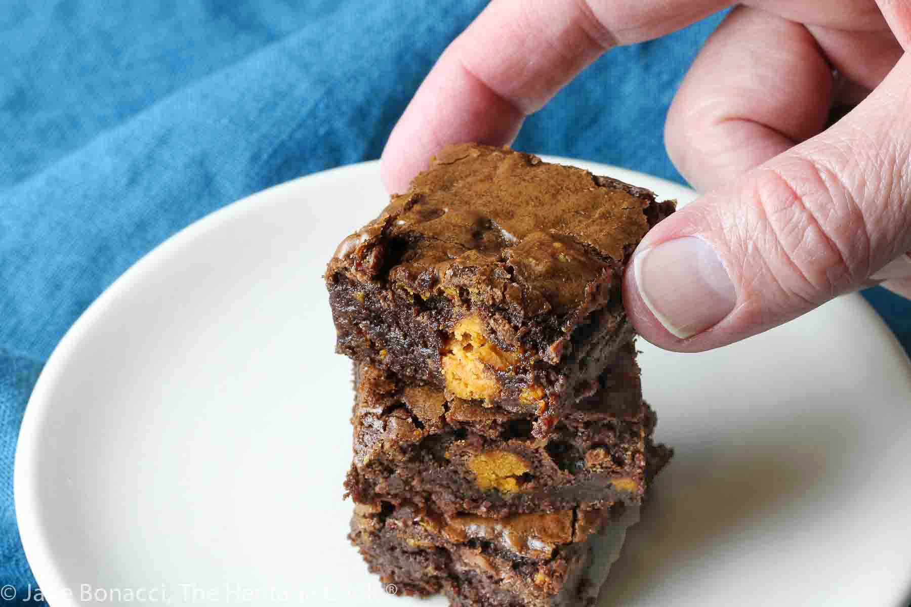 hand reaching for a brownie. 