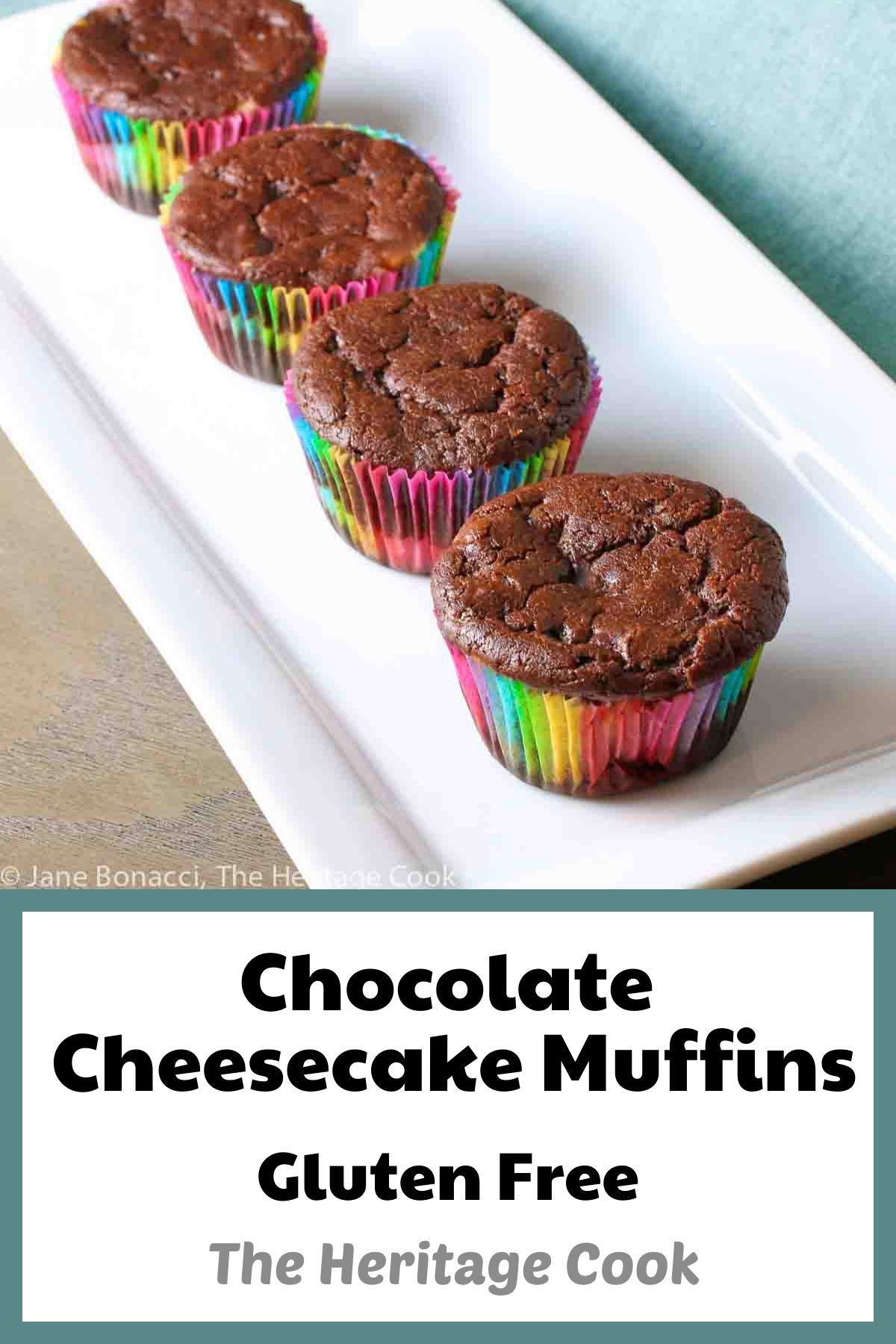 Chocolate Cheesecake muffins baked in rainbow colored paper liners, lined up on a white rectangular platter © 2024 Jane Bonacci, The Heritage Cook. 