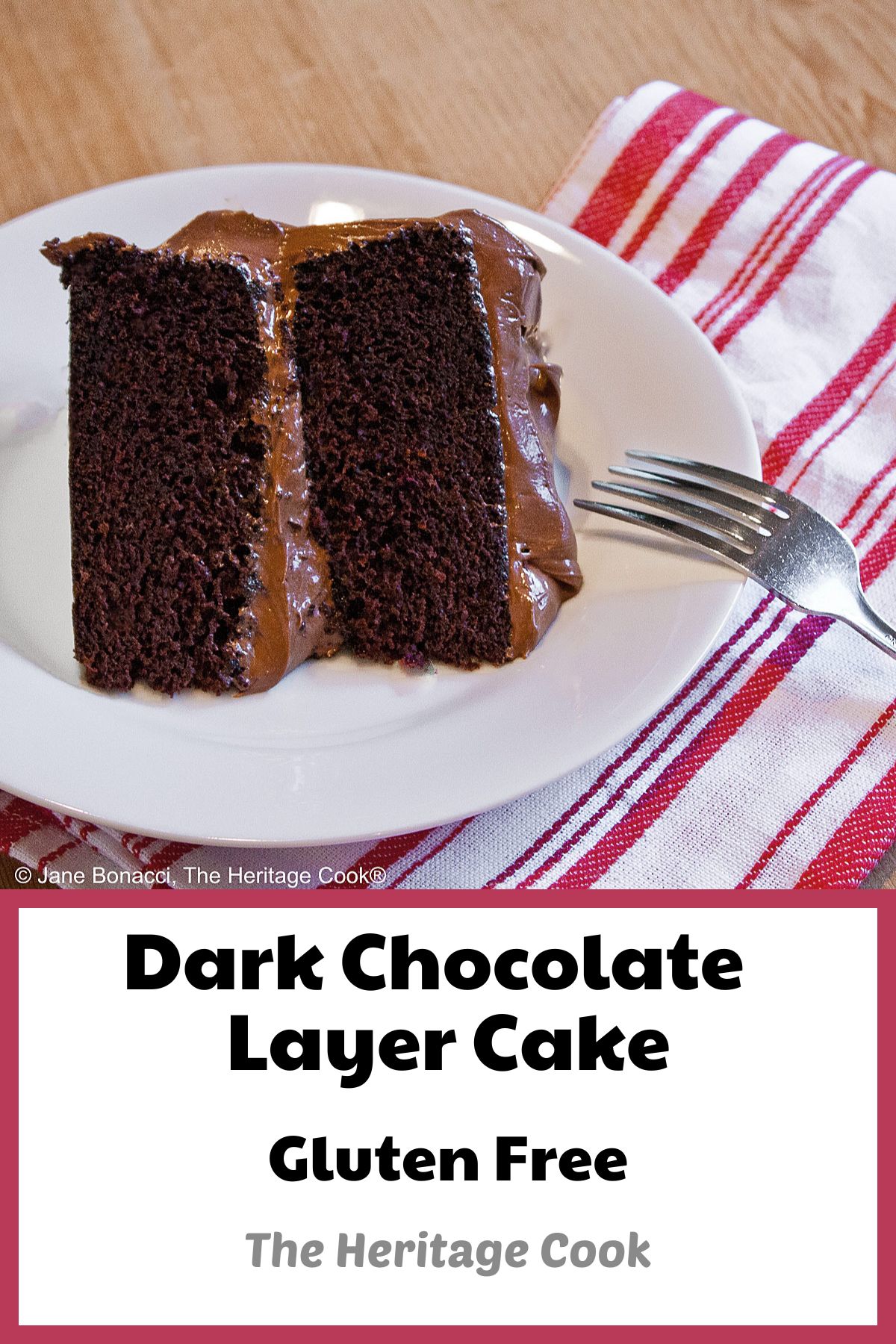 Slice of Dark Chocolate Layer Cake with Chocolate Frosting on a white plate with a red and white striped cloth and a fork © 2024 Jane Bonacci, The Heritage Cook. 