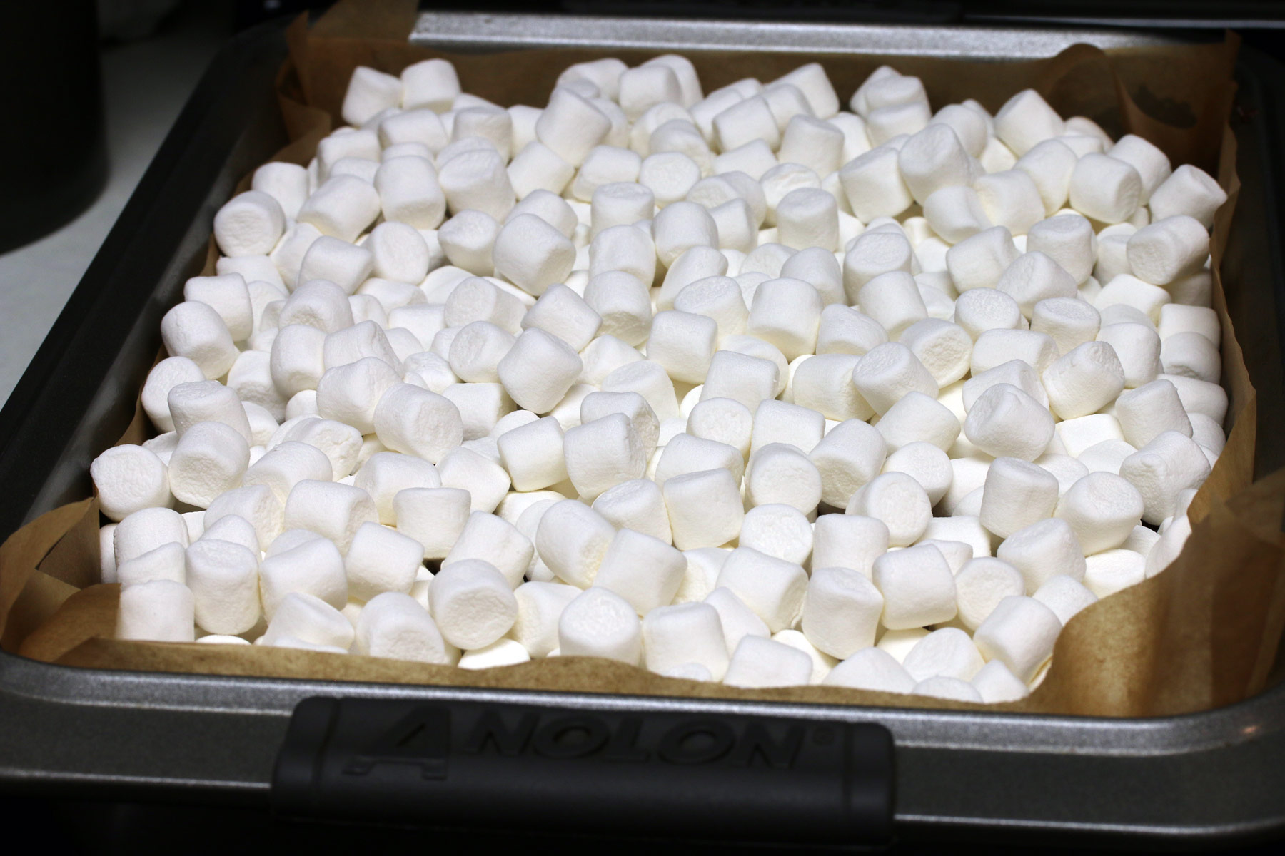 Mini marshmallows strewn over the top of piping hot brownies. 