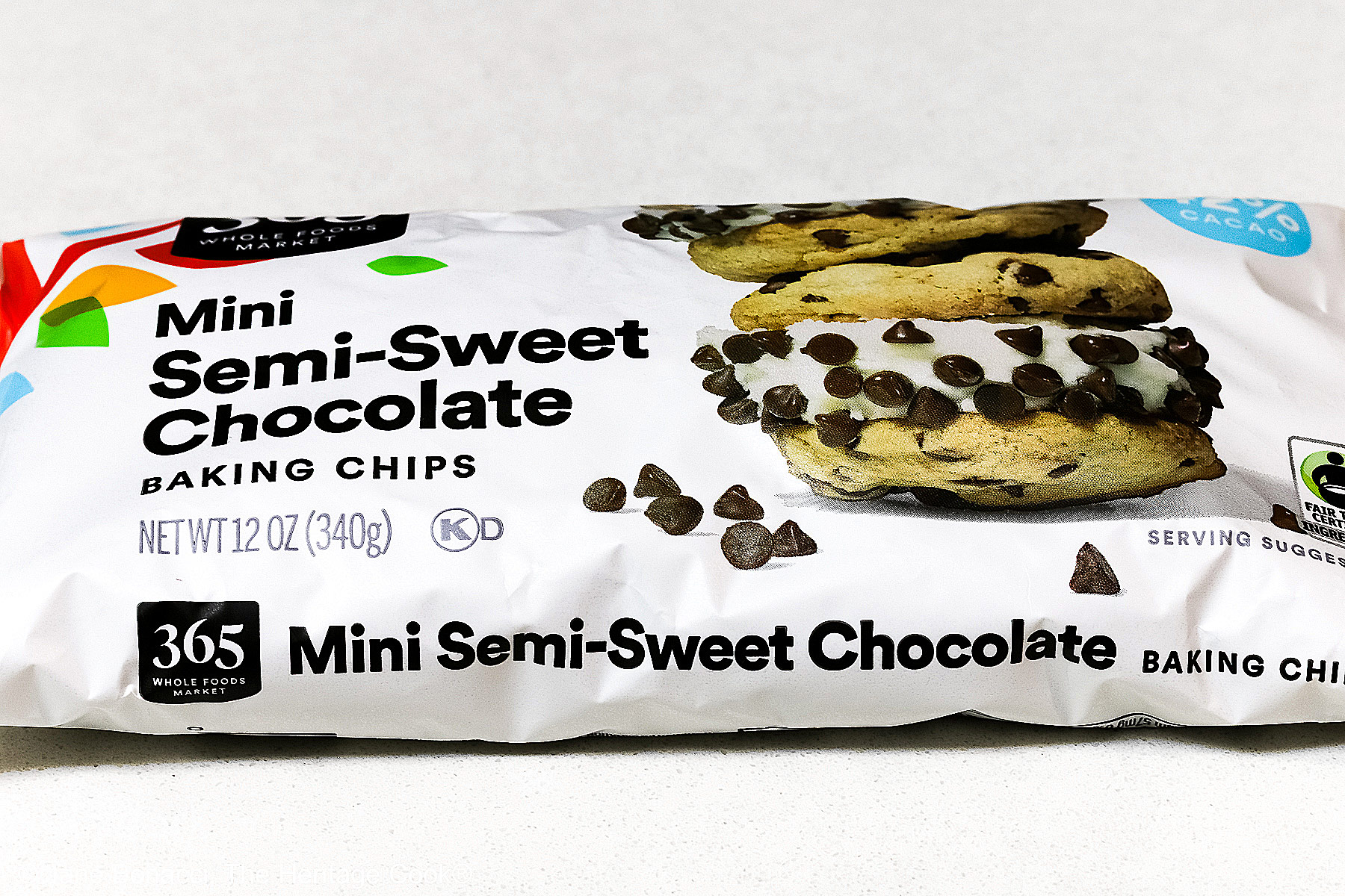 Bag of mini semisweet chocolate chips on a white background. 