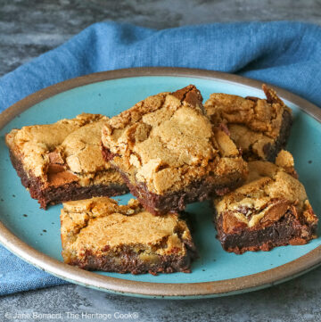 5 stacked Double Chocolate Brookies sitting on a turquoise colored plate with a medium blue cloth behind, on a mottled gray background © 2025 Jane Bonacci, The Heritage Cook.
