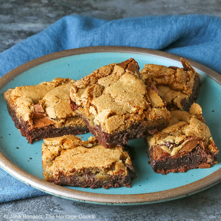 5 stacked Double Chocolate Brookies sitting on a turquoise colored plate with a medium blue cloth behind, on a mottled gray background © 2025 Jane Bonacci, The Heritage Cook.