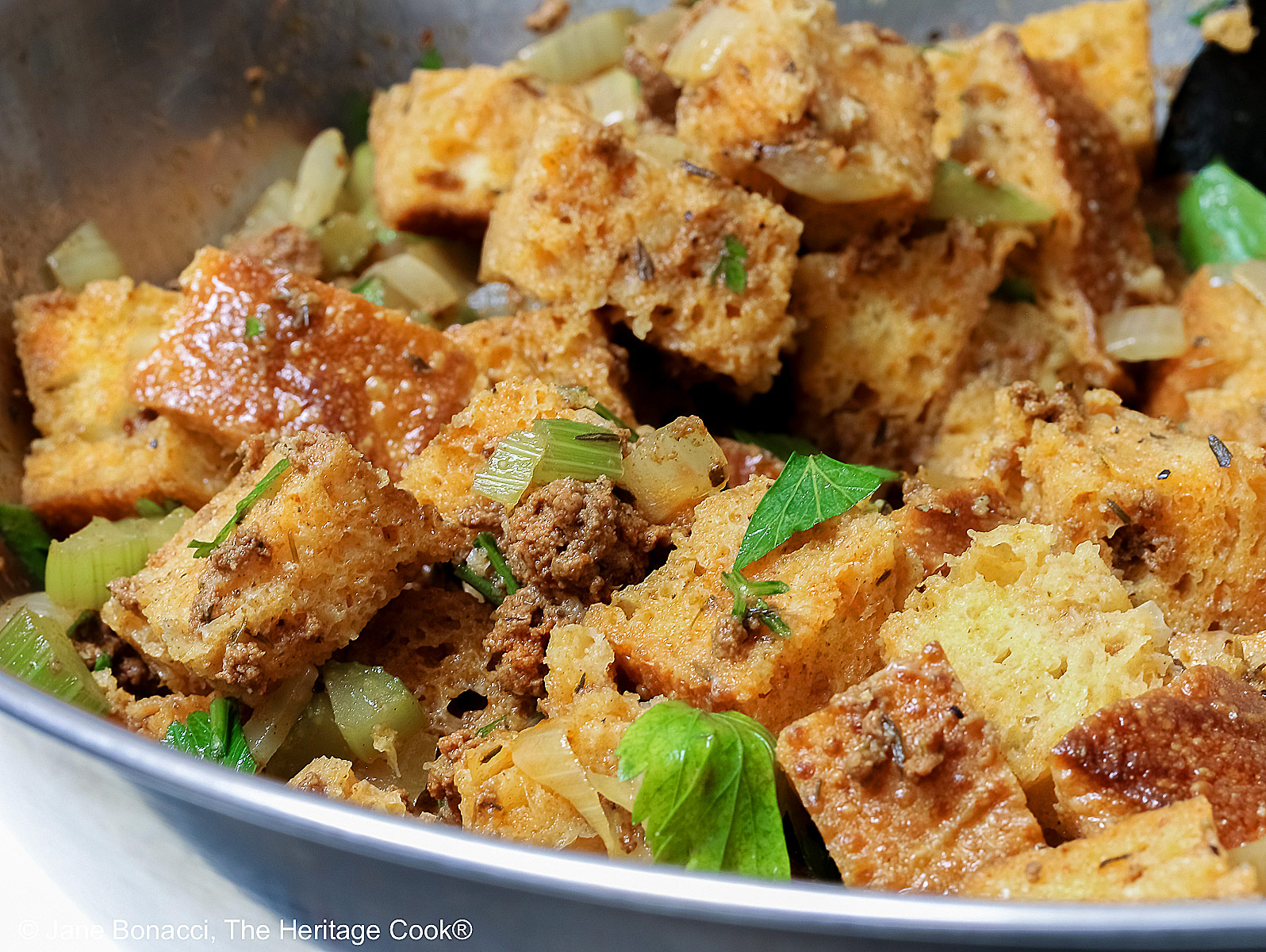 Large bowl of holiday stuffing muffins mix ready to be transferred to muffin tins. 