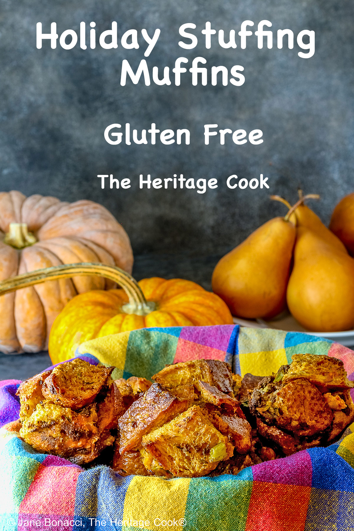 Craggy golden holiday stuffing muffins with chunks of bread and seasonings baked in a muffin tin to create round treats, tucked into a basket lined with a brightly colored cloth © 2025 Jane Bonacci, The Heritage Cook. 