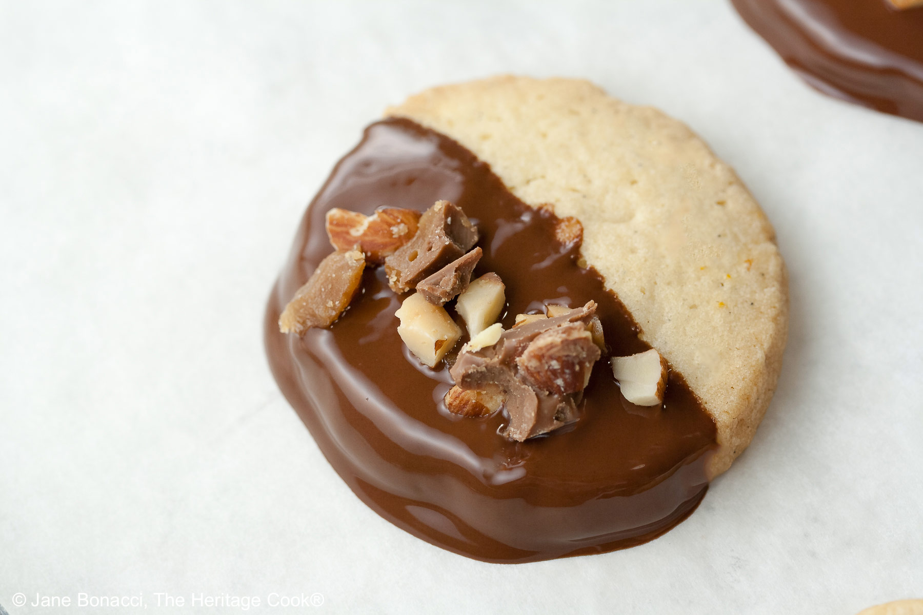 Single dipped cookie on a parchment covered sheet pan, cooling and firming up.