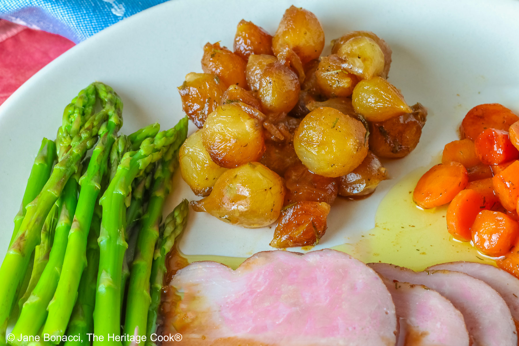Focus on my side dishes, steamed asparagus spears, glazed pearl onions, and dilled carrots with a butter glaze.