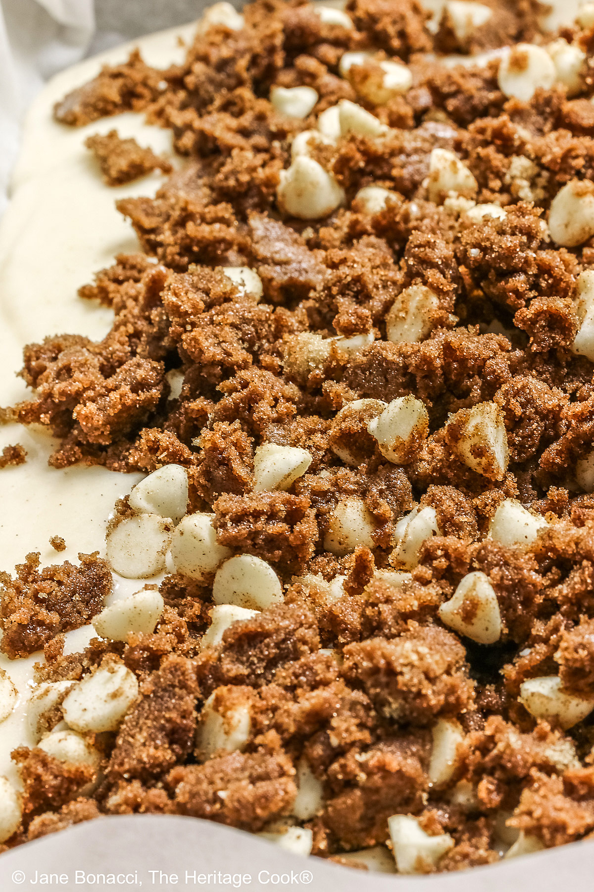 Cake batter topped with dollops of the cinnamon topping, ready for the oven.