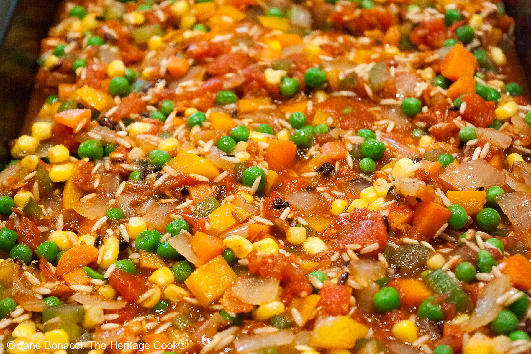 Pan full of brightly colored sauteed vegetables.