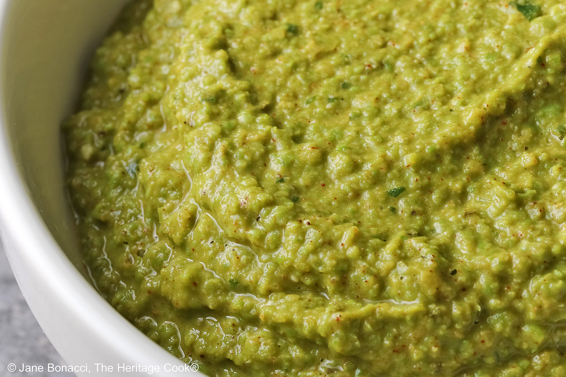 Close up look at the pea puree in the white bowl.