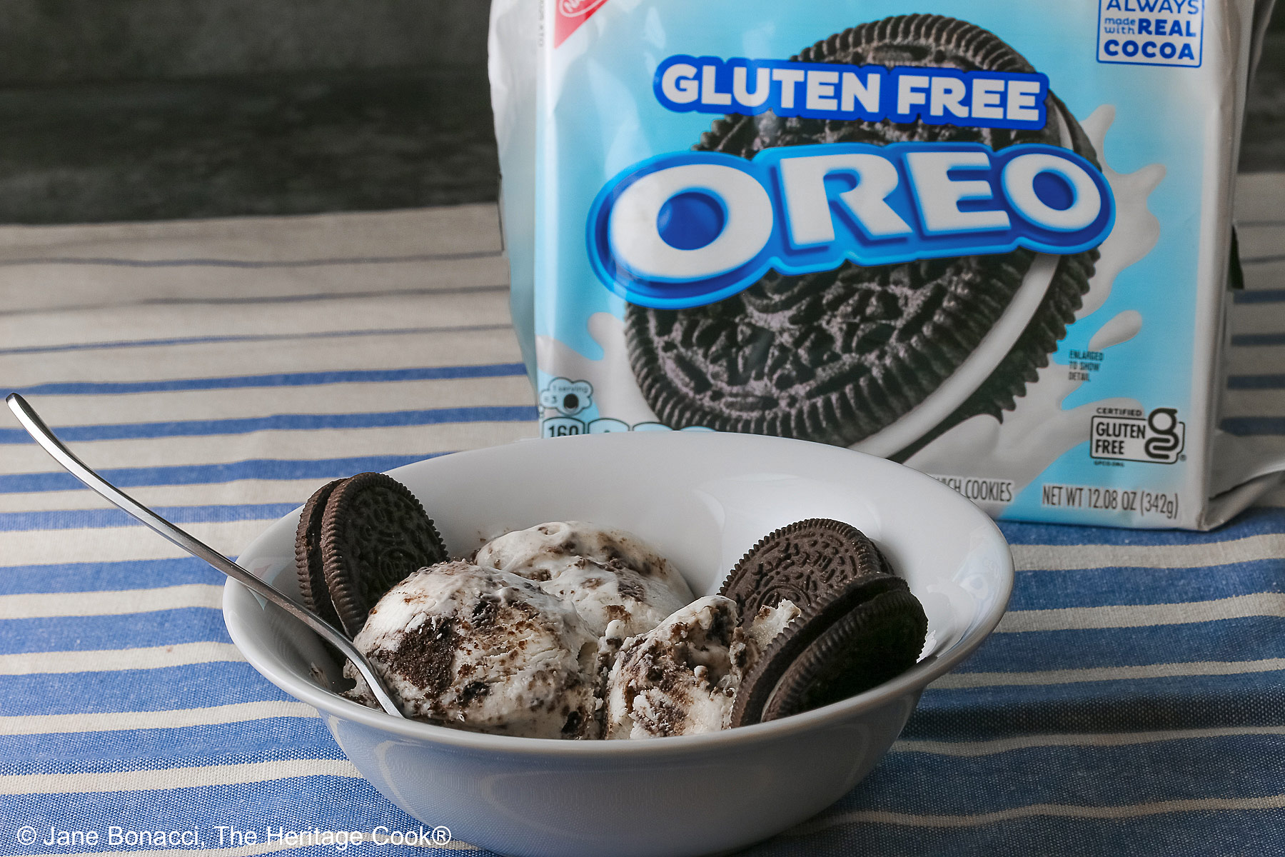 Bowl of ice cream with whole Oreo cookies with a box of Gluten Free Oreo cookies.