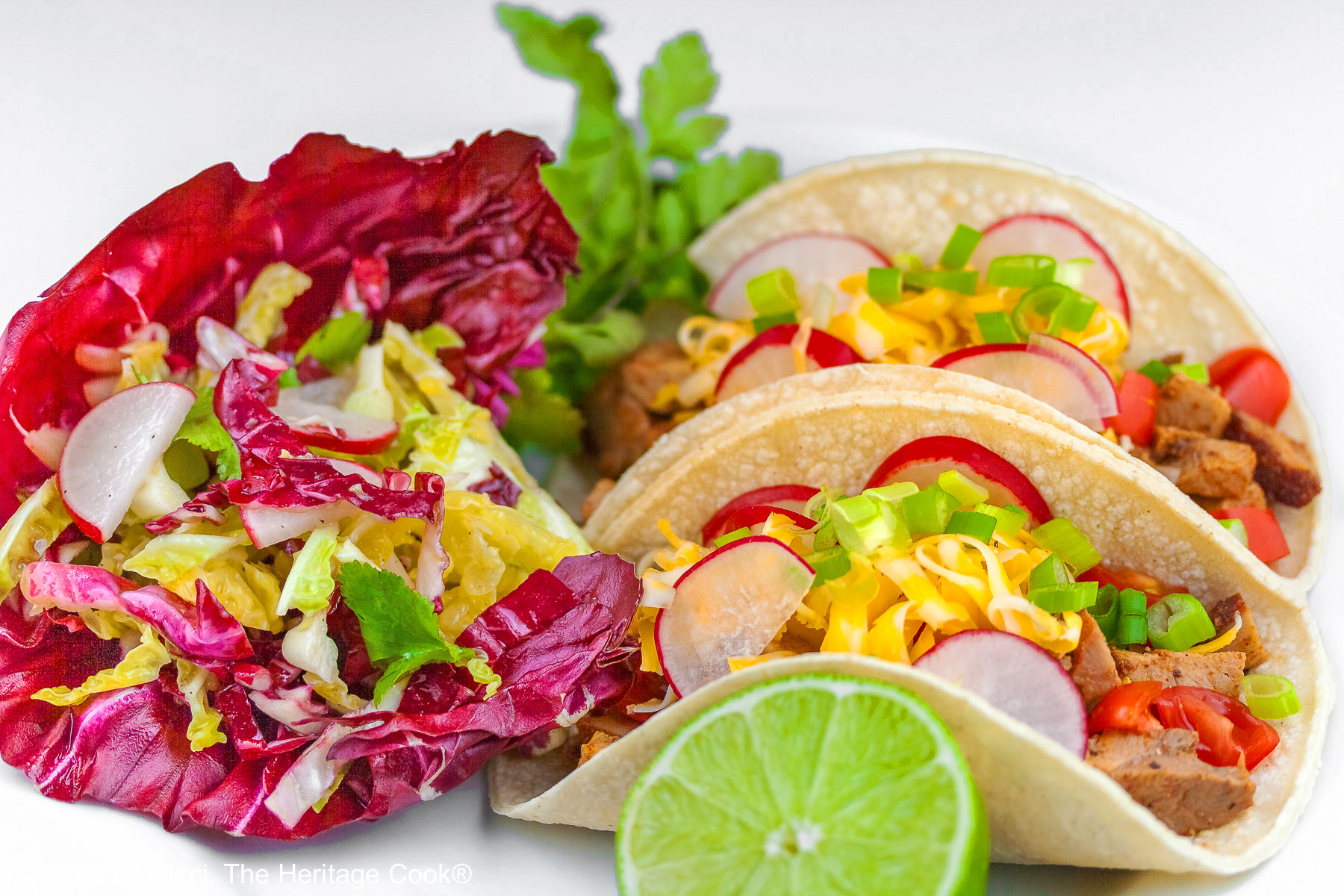 Beautiful tacos next to a pile of the South of the Border slaw.
