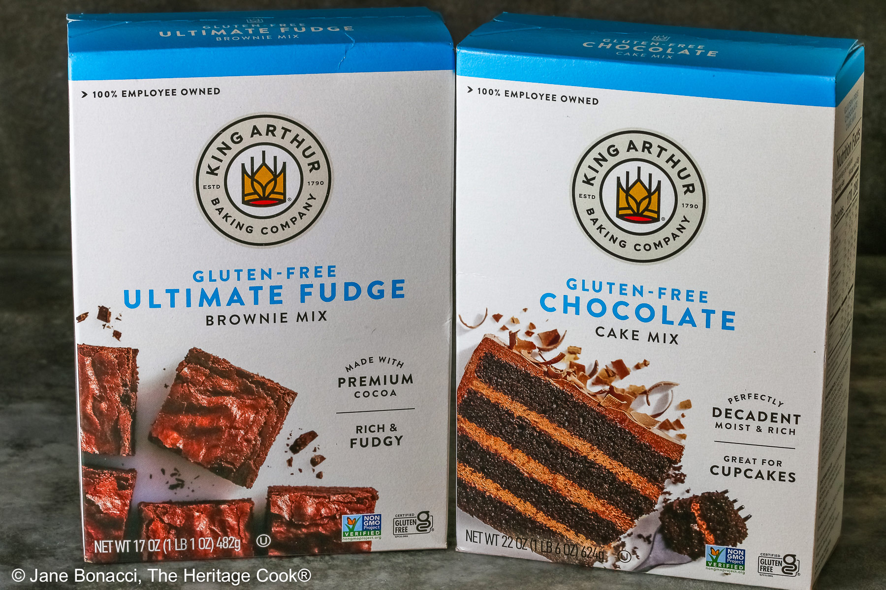 Boxes of gluten-free chocolate cake mix and gluten-free fudgy brownie mix.